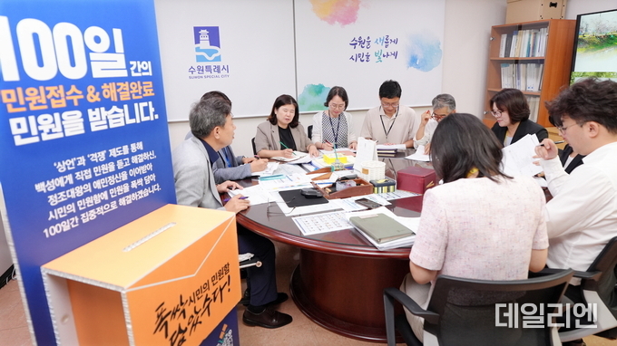 수원시 시민의 민원함 민원컨설팅TF 회의에서 참석자들이 민원 해결을 위해 머리를 맞대고 있다.